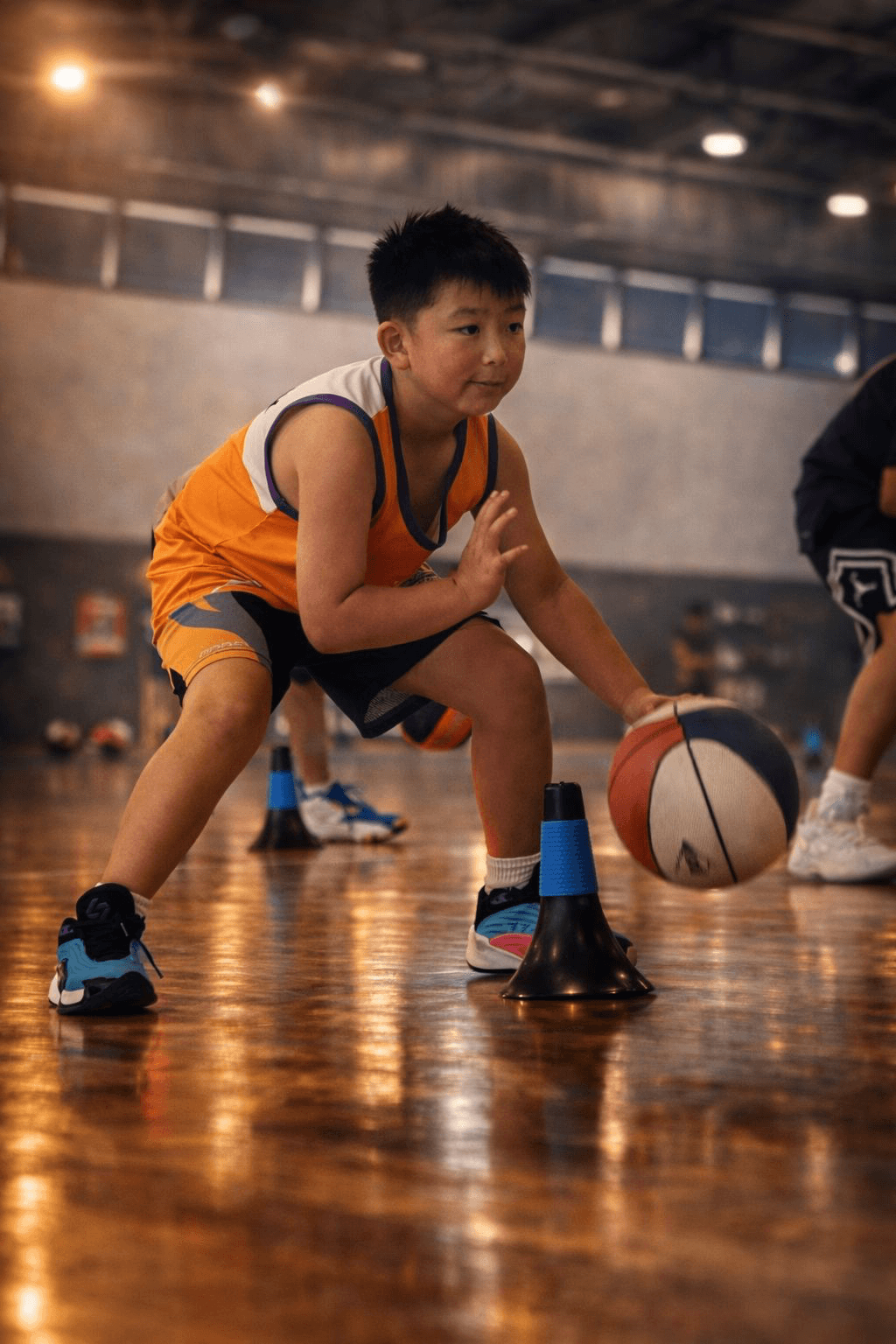 Young basketball player performing dribbling drills during a training session